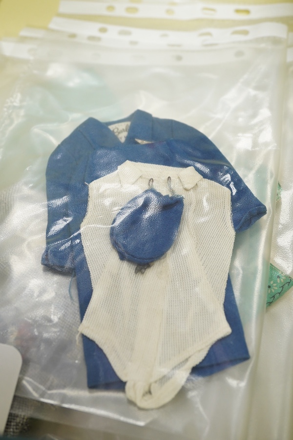 A 1960's Mattel Inc. Barbie doll, 1963, together with a Skipper doll, and a collection of eight original outfits with accessories, sorted into individual packets, outfits purchased between 1963 to 1966 include; American